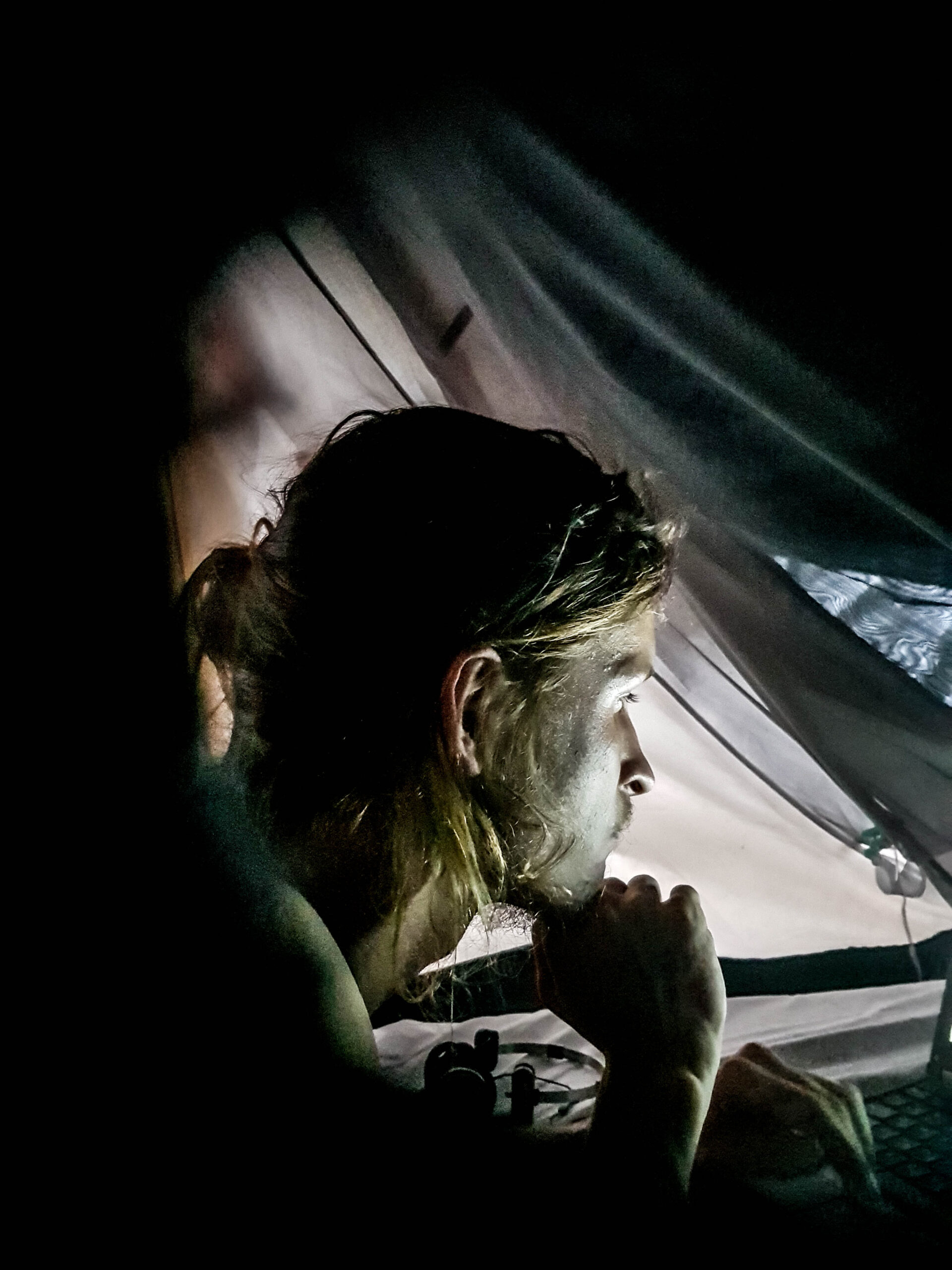 A man on his computer in the dark