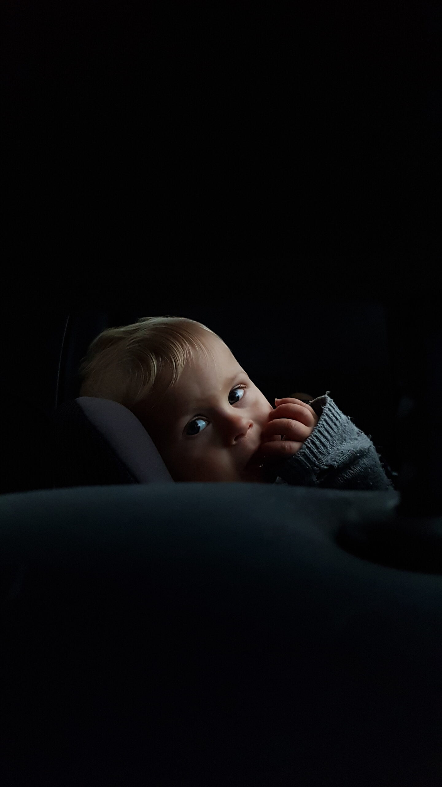 Child in front of a black background